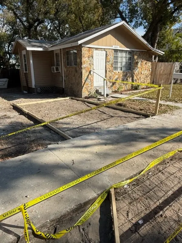 Concrete driveway replacement preparation with forms and rebar at residential property