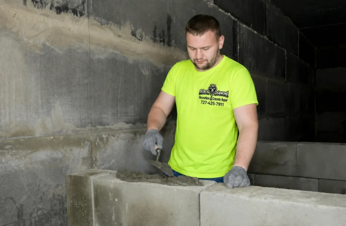 Construction worker finishing a concrete wall