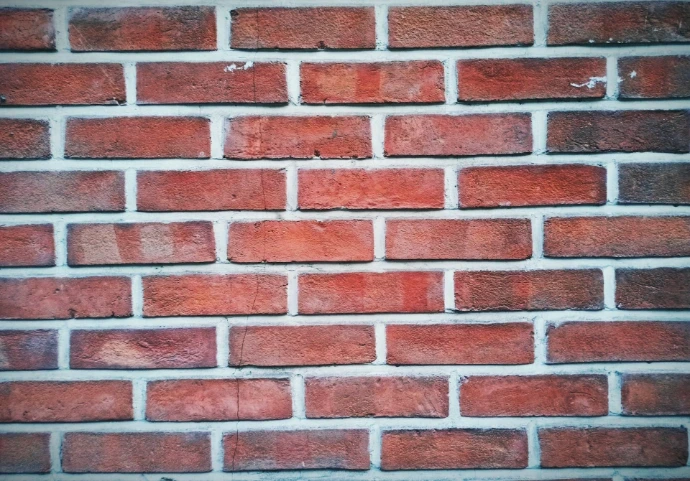 A close up of a red brick wall
